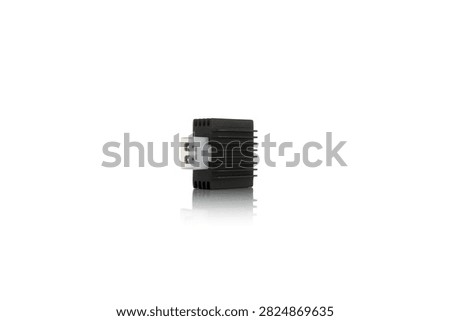 Studio macro close up of motorcycle voltage regulator rectifier featuring black cast aluminum heat sink cooling fins, white plastic side socket pin connector, three quarter angle perspective, and soft mirror reflection, isolated on pure white background for auto parts mockup.