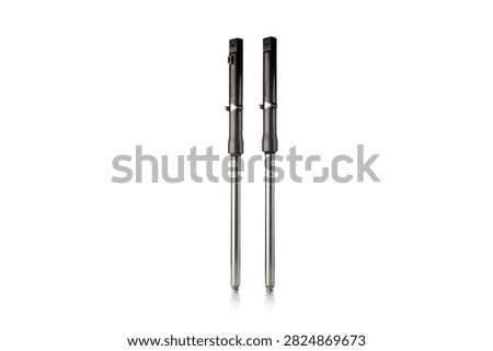 Studio macro close up of pair of front motorcycle suspension fork legs featuring polished chrome stanchion tubes, durable black painted lower sliders, vertical parallel alignment, and soft mirror reflection, isolated on pure white background for auto parts mockup.