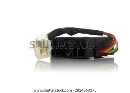 Studio macro shot of motorcycle voltage regulator rectifier with aluminum heatsink fins, wiring harness, and 4-pin plastic connector, isolated on white background with mirror reflection for auto spare parts catalog mockup.