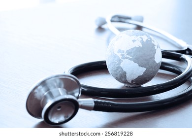 Studio macro of a stethoscope and texture globe with shallow DOF evenly matched abstract as medical network concept