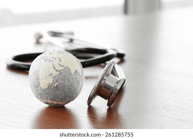 Studio macro of a stethoscope and texture globe with shallow DOF evenly matched abstract as medical network concept Elements of this image furnished by NASA