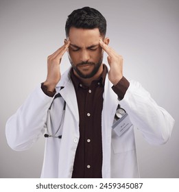 Studio, male doctor and pain of headache in stress, burnout and mental health of medical employee. Tired, healthcare worker or man with migraine, anxiety and overworked pressure by white background - Powered by Shutterstock