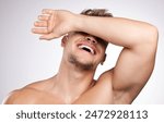 Studio, man and hand on face for skincare, wellness and cosmetics for beauty with laugh. White background, male model and shy with facial covering, skin glow and feeling fresh while topless with joy