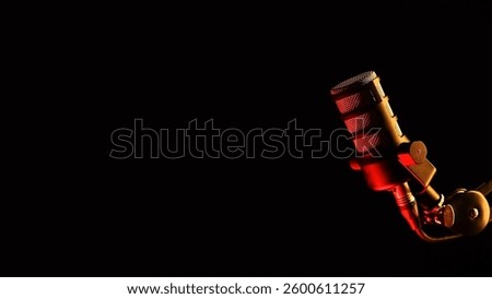 Studio microphone with dramatic red lighting