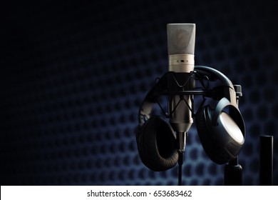 Studio Microphone And Headphones On Mic Stand Against Gray Background