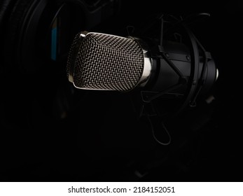 Studio Microphone On A Black Background. Minimalism. Close-up. Singing, Concert, Rehearsal, Speaker. Night Club, Radio, Performance. There Are No People In The Photo. Advertising, Banner.