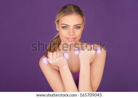 Studio photo of attractive woman exercising with dumbbell free weights.