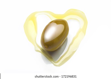 studio photo of olive in heart shaped olive oil with heart shaped reflection of soft box