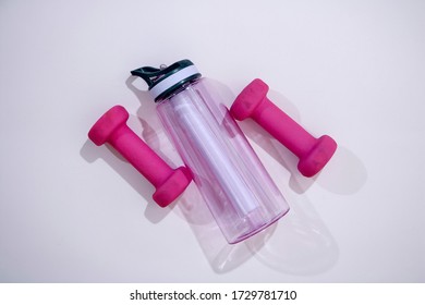 A studio photo of pink dumbells - Shutterstock ID 1729781710