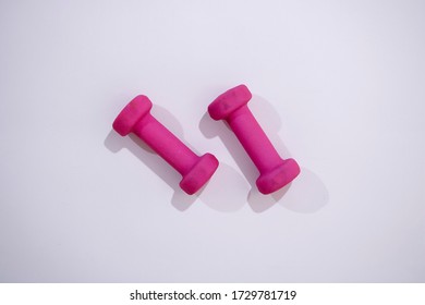 A Studio Photo Of Pink Dumbells