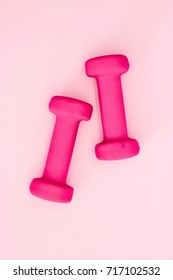 A Studio Photo Of Pink Dumbells