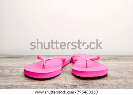 A studio photo of pink flip flops