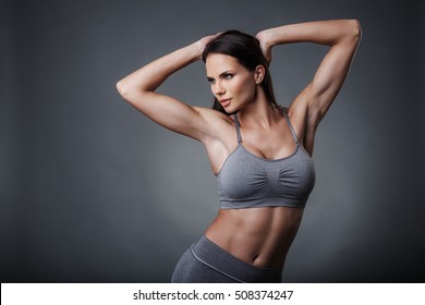 Studio Photo Of Posing Sexy Woman With Nice Fitness Body Isolated Over Gray Background