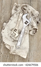 A Studio Photo Of A Wrench On An Oily Rag