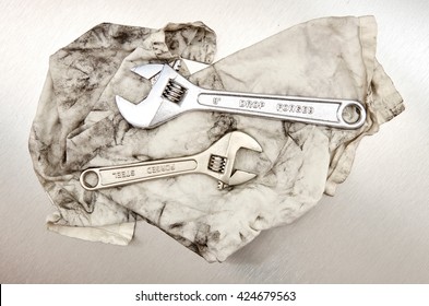 A Studio Photo Of A Wrench On An Oily Rag