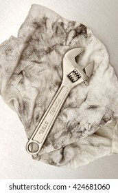 A Studio Photo Of A Wrench On An Oily Rag