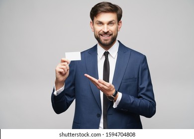 Studio Photo Of Young Handsome Businessman Wearing Suit Holding Business Card