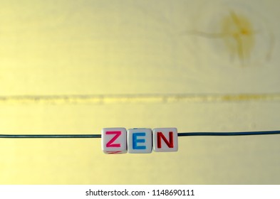 A Studio Photograph of Alphabetical Beads Suspended on a Wire Spelling 'Zen' - Shutterstock ID 1148690111