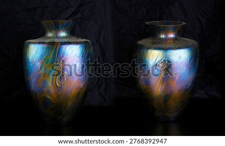 studio photograph featuring a pair of exquisite antique art glass vases by the renowned Austrian manufacturer Loetz (Klášterský Mlýn). These masterpieces of Art Nouveau (Secession) design are famous for their stunning iridescent 
