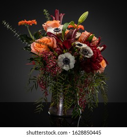 Studio Photography Of Floral Arrangements On A Gray Backdrop With Orange Palette