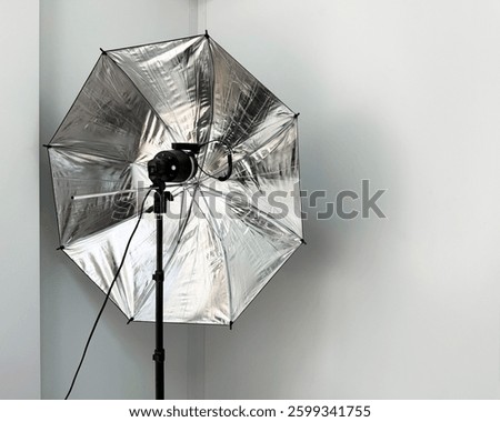 Studio photography lighting setup with reflective umbrella