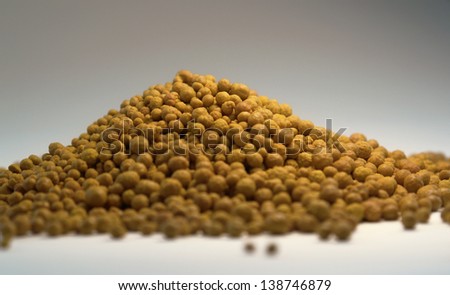 studio photography of a pile of ferric chloride balls in light back