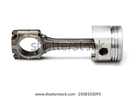 Studio photography of a piston with connecting rod with shadow isolated on a white background. Close-up shot of a new car engine spare part. 