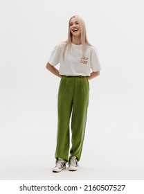 Studio Photoshoot Of A Smiling Young Blond Woman Wearing Casual Clothing Against A White Background.  Natural Makeup And Hairstyle.