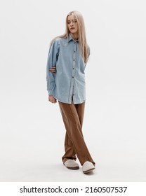 Studio Photoshoot Of A Smiling Young Blond Woman Wearing Casual Clothing Against A White Background.  Natural Makeup And Hairstyle.