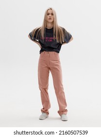 Studio Photoshoot Of A Smiling Young Blond Woman Wearing Casual Clothing Against A White Background.  Natural Makeup And Hairstyle.