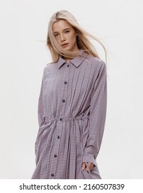 Studio Photoshoot Of A Smiling Young Blond Woman Wearing Casual Clothing Against A White Background.  Natural Makeup And Hairstyle.