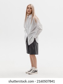 Studio Photoshoot Of A Smiling Young Blond Woman Wearing Casual Clothing Against A White Background.  Natural Makeup And Hairstyle.