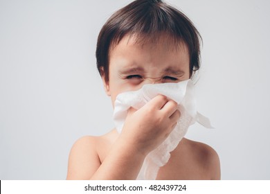 Studio Picture From A Baby With Handkerchief. Sick Child Isolated Has Runny Nose.