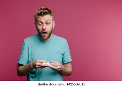 studio picture from a young man with handkerchief going to sneeze. Sick guy isolated has runny nose. man makes a cure for the common cold from the air conditioner - Shutterstock ID 1425509015