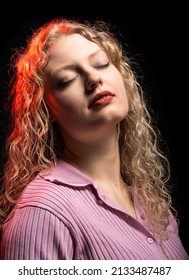 Studio Portrait Of A 21 Year Old White Blonde Woman With Curling Hair, Eyes Closed