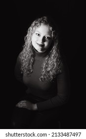 Studio Portrait Of A 21 Year Old White Blonde Woman With Curling Hair