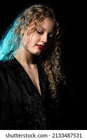 Studio Portrait Of A 21 Year Old White Blonde Woman With Curling Hair