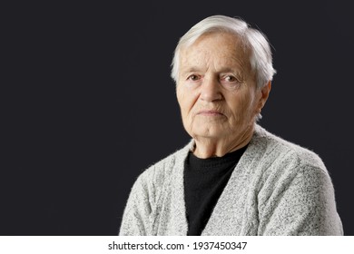 Studio Portrait Of 80 Years Old Woman On Black Background