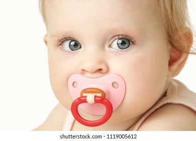 Studio Portrait Of Adorable Baby Girl With Pacifier