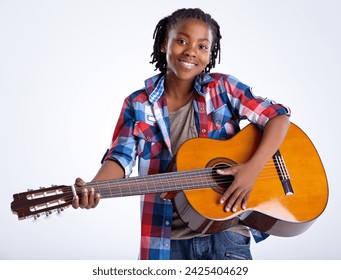 Studio, portrait or African child with guitar or smile playing song or music isolated on white background. Happy boy, artist or creative kid with acoustic instrument, practice performance or talent - Powered by Shutterstock