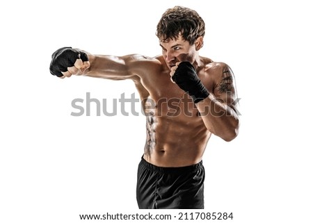 Studio Portrait of aggressive kickboxer training and practicing jab Isolated on white studio background. Concept of sport, healthy lifestyle. 