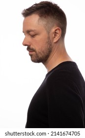 Studio Portrait Of An Attractive 40 Year Old Man Wearing A Black Shirt. 