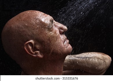 Studio Portrait Of A Bald Old Man Showering