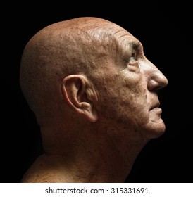 studio portrait of a bald old man