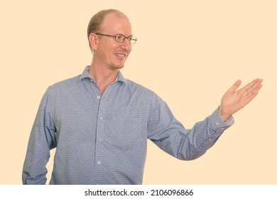 Studio Portrait Of Balding Man With Short Hair Against Plain Studio Background