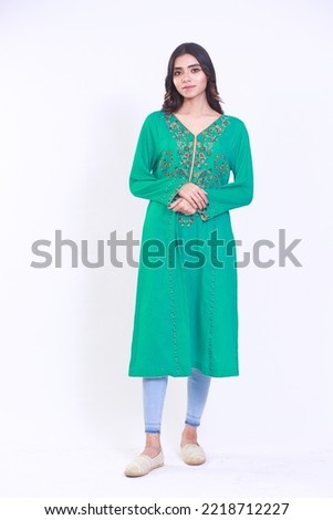 studio portrait of a beautiful Pakistani  woman, Urban desi girl wearing a green Kurti isolated on white background