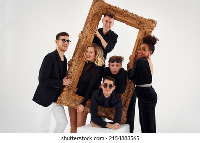 Studio Portrait Of Beautiful Young Diverse Group Of Friends Isolated On White Background In The Frame For A Picture, Goofy Face, Good Mood