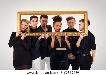 studio portrait of Beautiful young diverse group of friends isolated on white background in the frame for a picture, goofy face, good mood