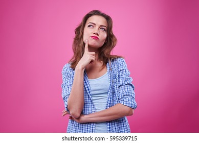 Studio portrait of beautiful young woman thinking and looking upwards. The concept of perception and reflection  - Shutterstock ID 595339715