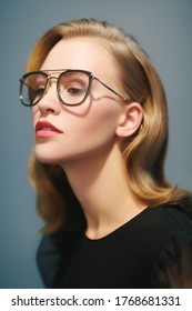 Studio Portrait Of A Beauty Fashion Blonde Model Girl Wearing Stylish Glasses. Optics Style, Eyewear.